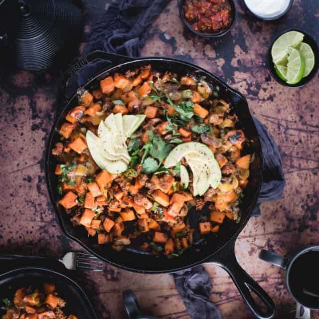 overhead picture of sweet potato skillet with avocado on top 