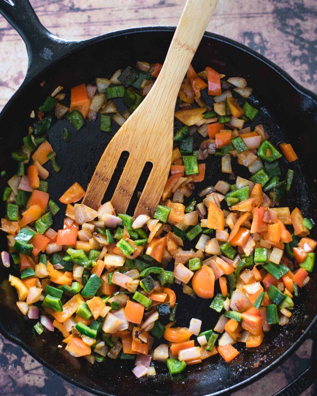 sautéed peppers, onions and other veggies in a skillet
