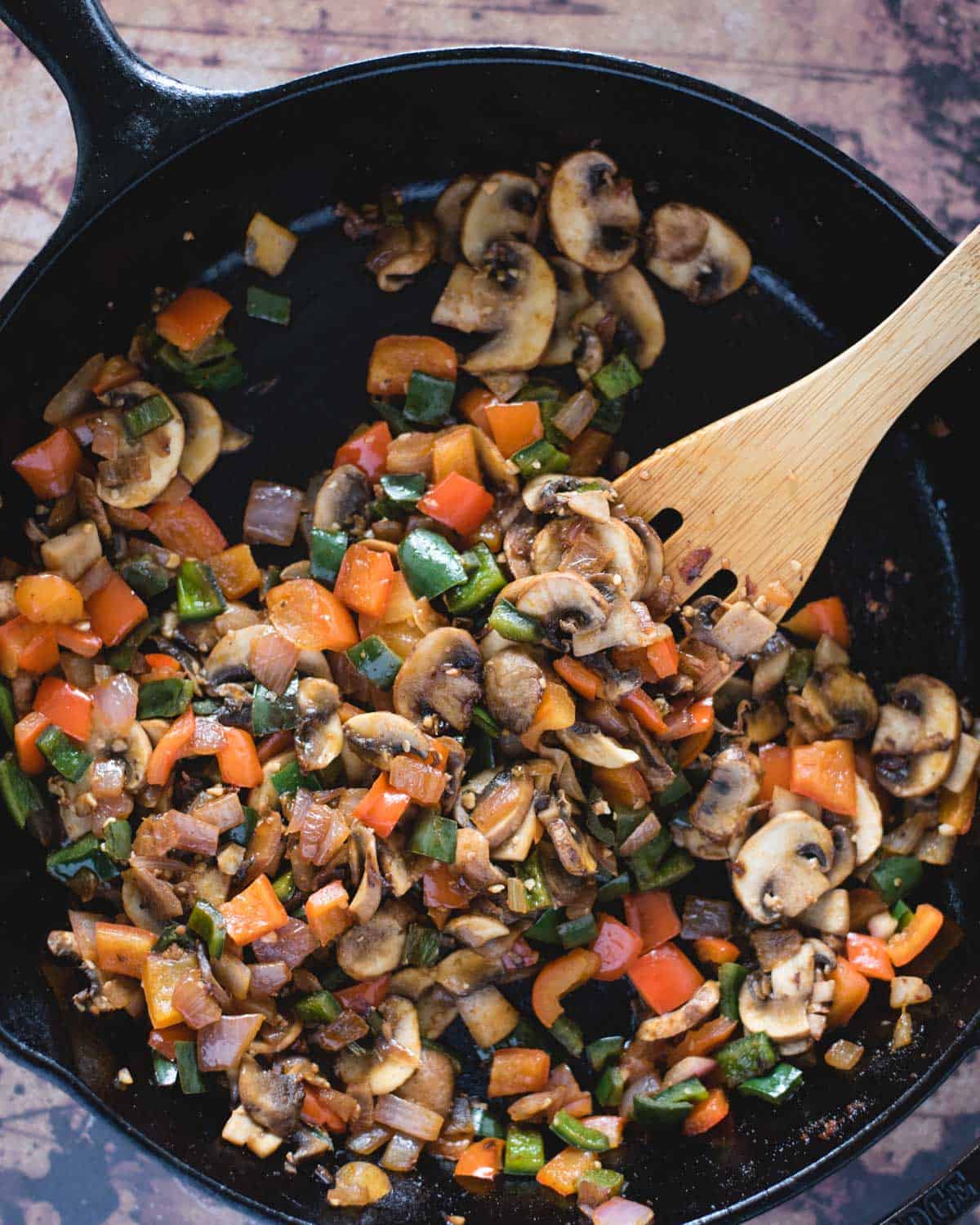 sautéed sliced mushrooms, peppers and onions in a skillet