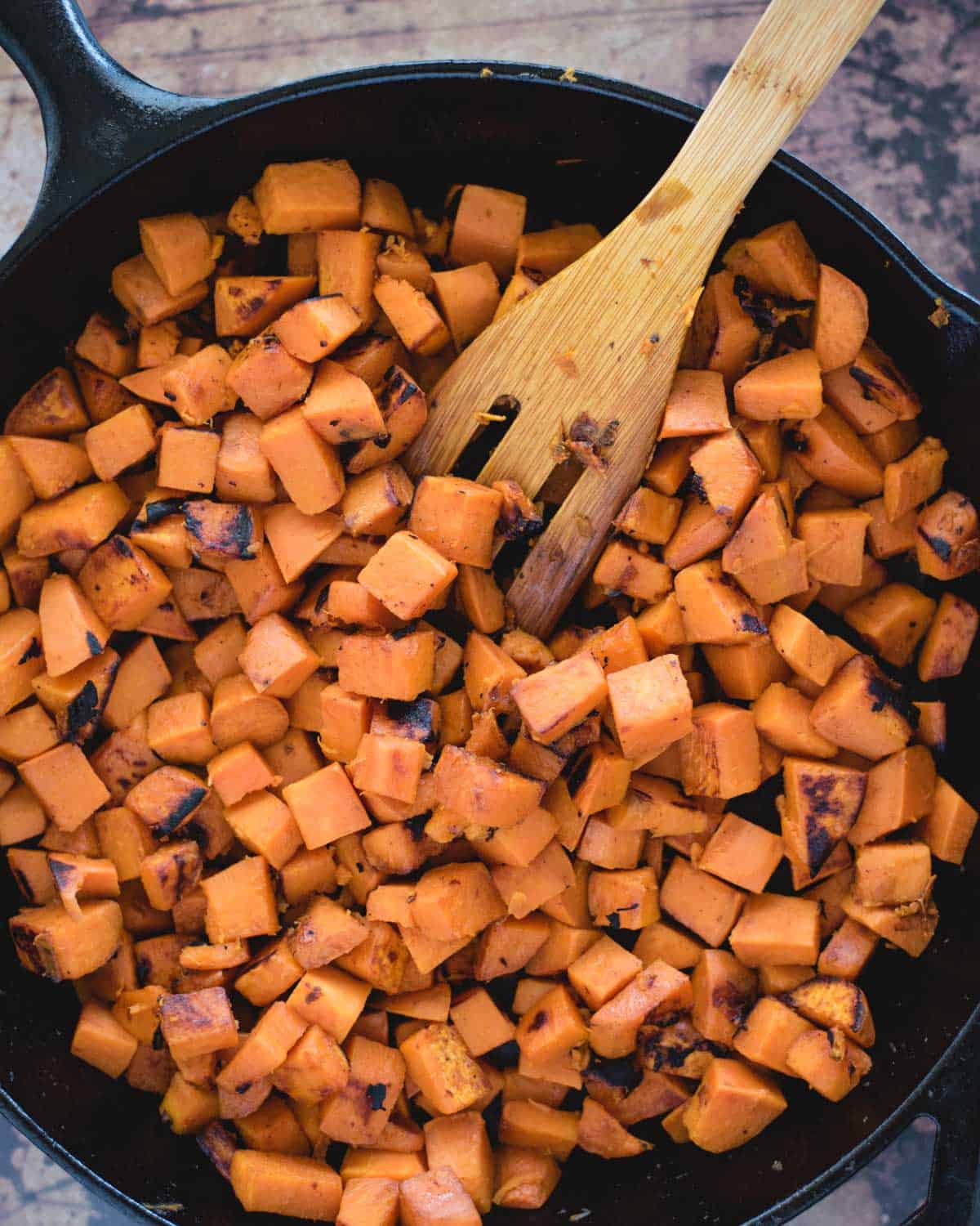 cooked sweet potato pieces in a skillet