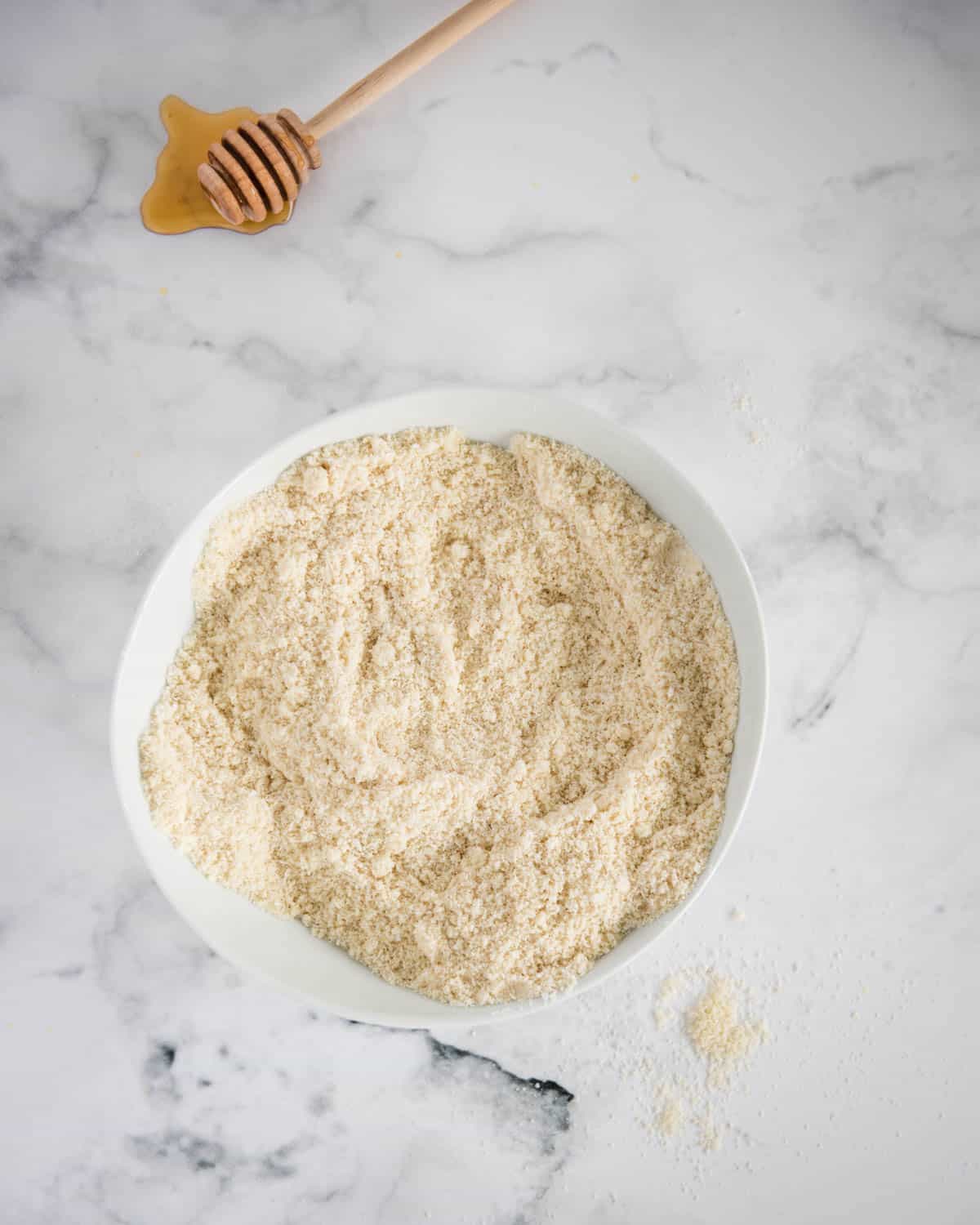bowl of flour and other muffin ingredients  on white background