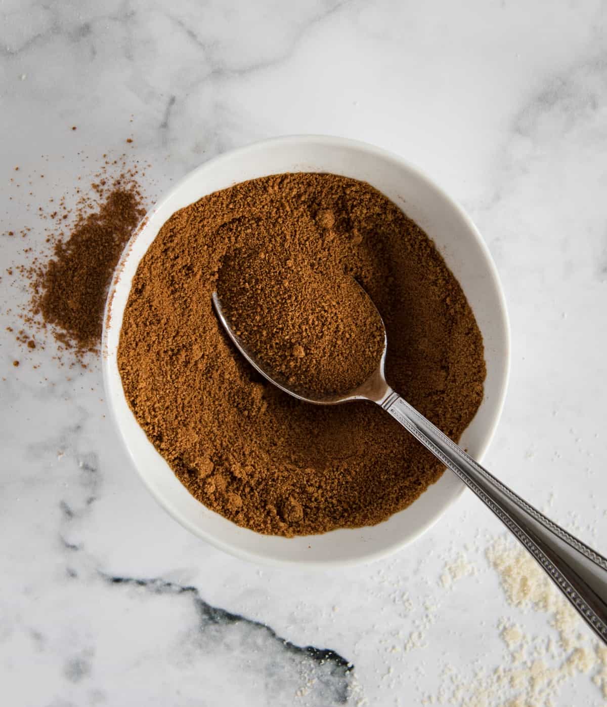 bowl of coconut sugar and cinnamon on a white background 