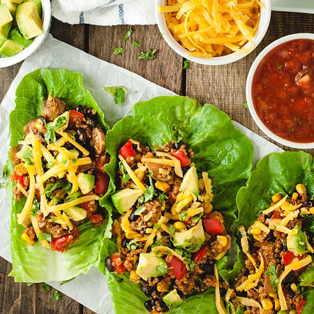 Close up overhead shot of taco black bean lettuce wraps on a dark background