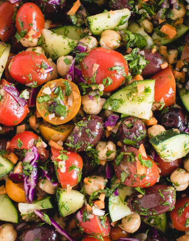 Very close up macro picture of a mediterranean vegan chickpea salad tossed in herb dressing