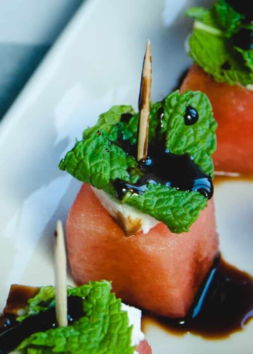 Close up picture of a watermelon mint toothpick skewer with balsamic glaze