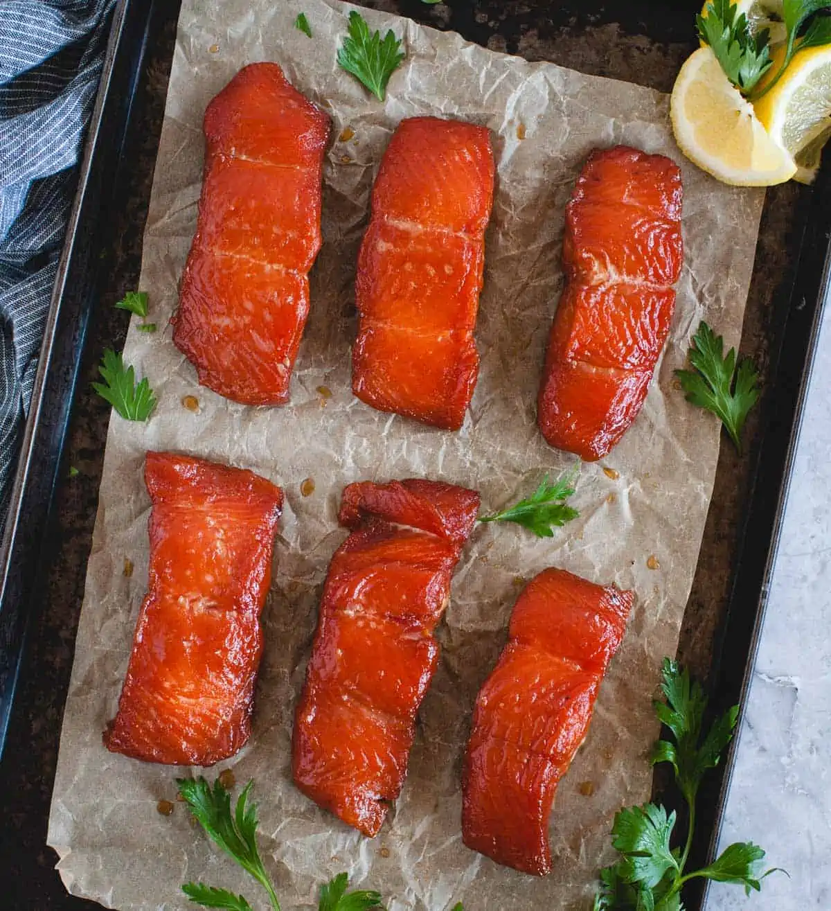 overhead vertical of 6 pieces of smoked salmon laid flat on a tray