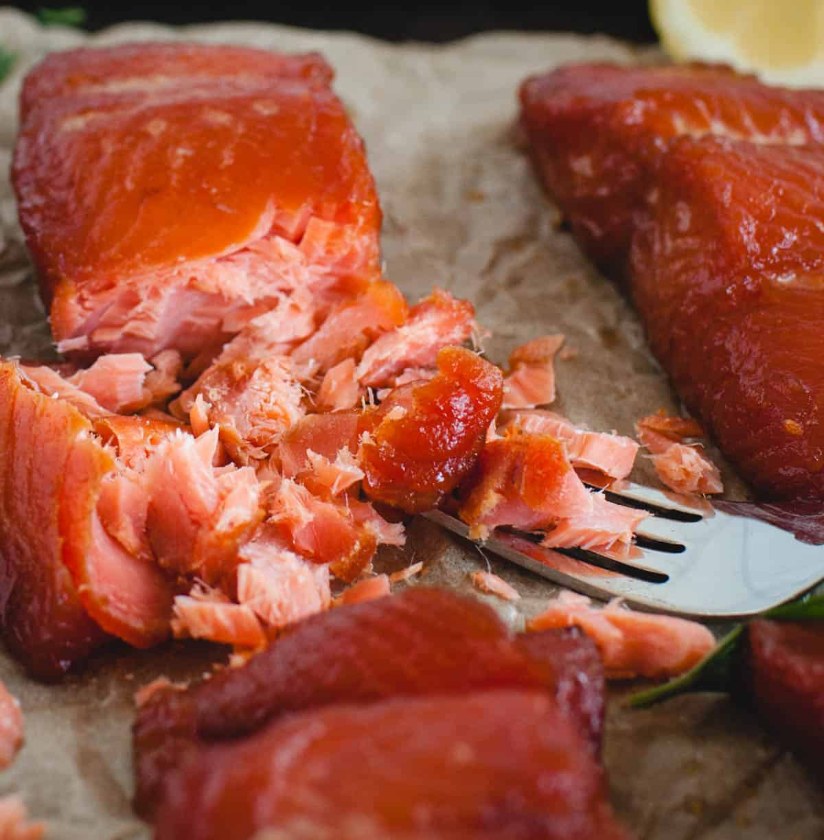 Angled shot of smoked salmon resting on a fork