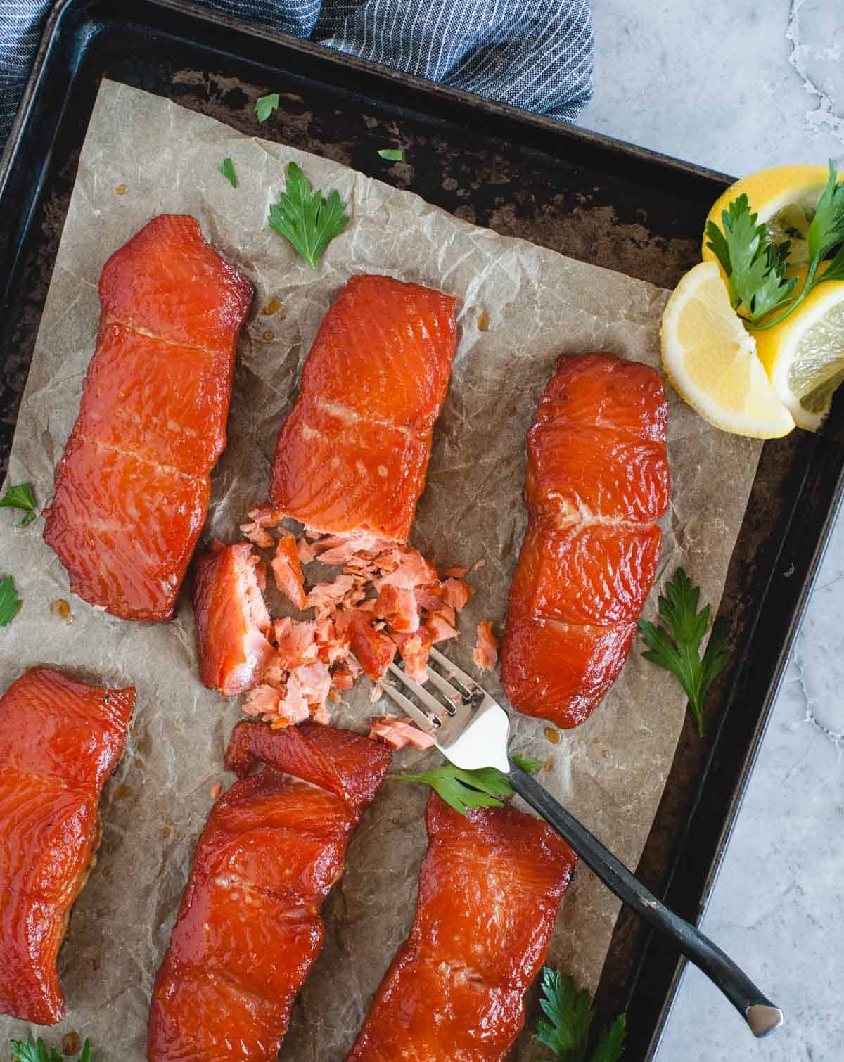 overhead of smoked salmon pieces with one broken up by a fork