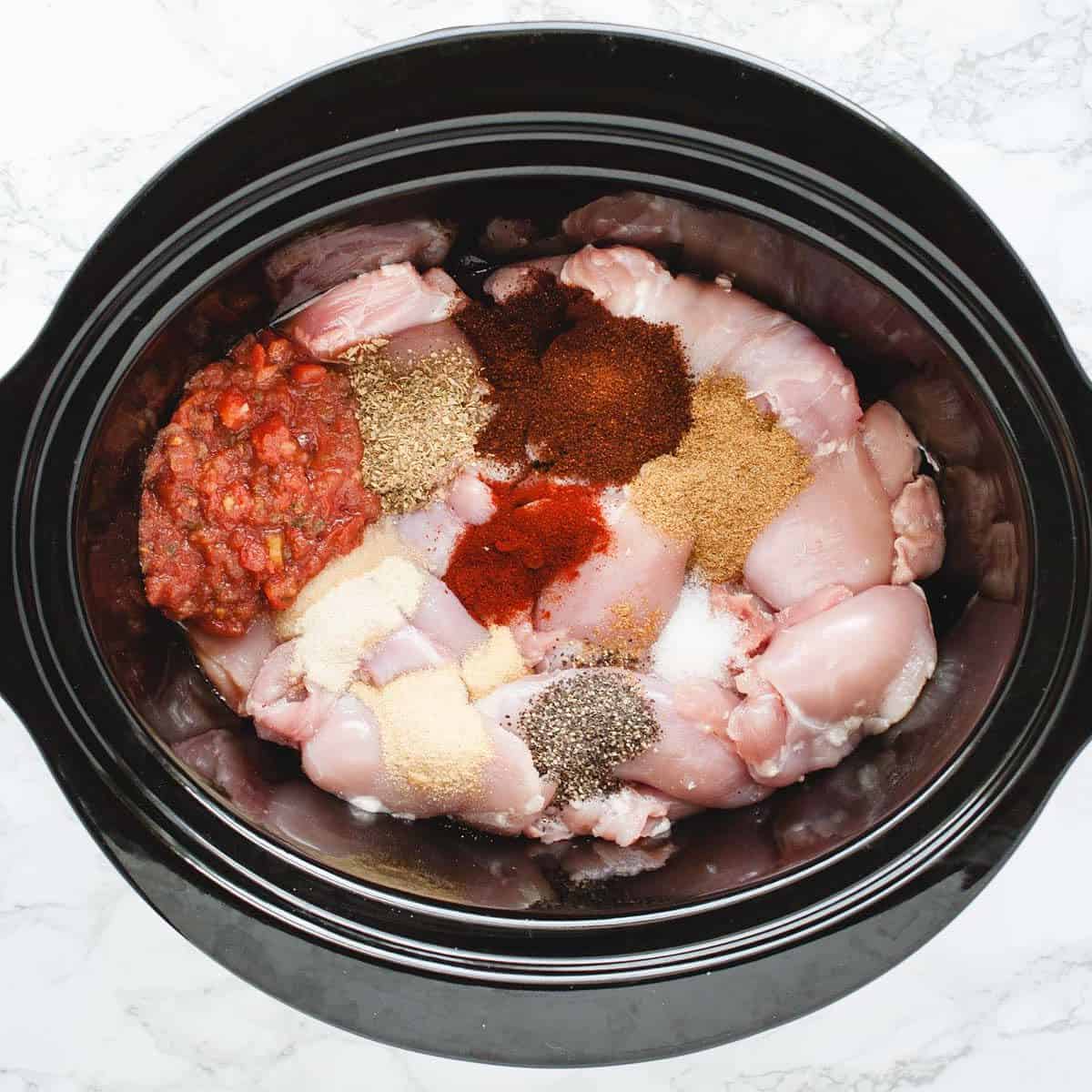 chicken, salsa and spices in a crockpot
