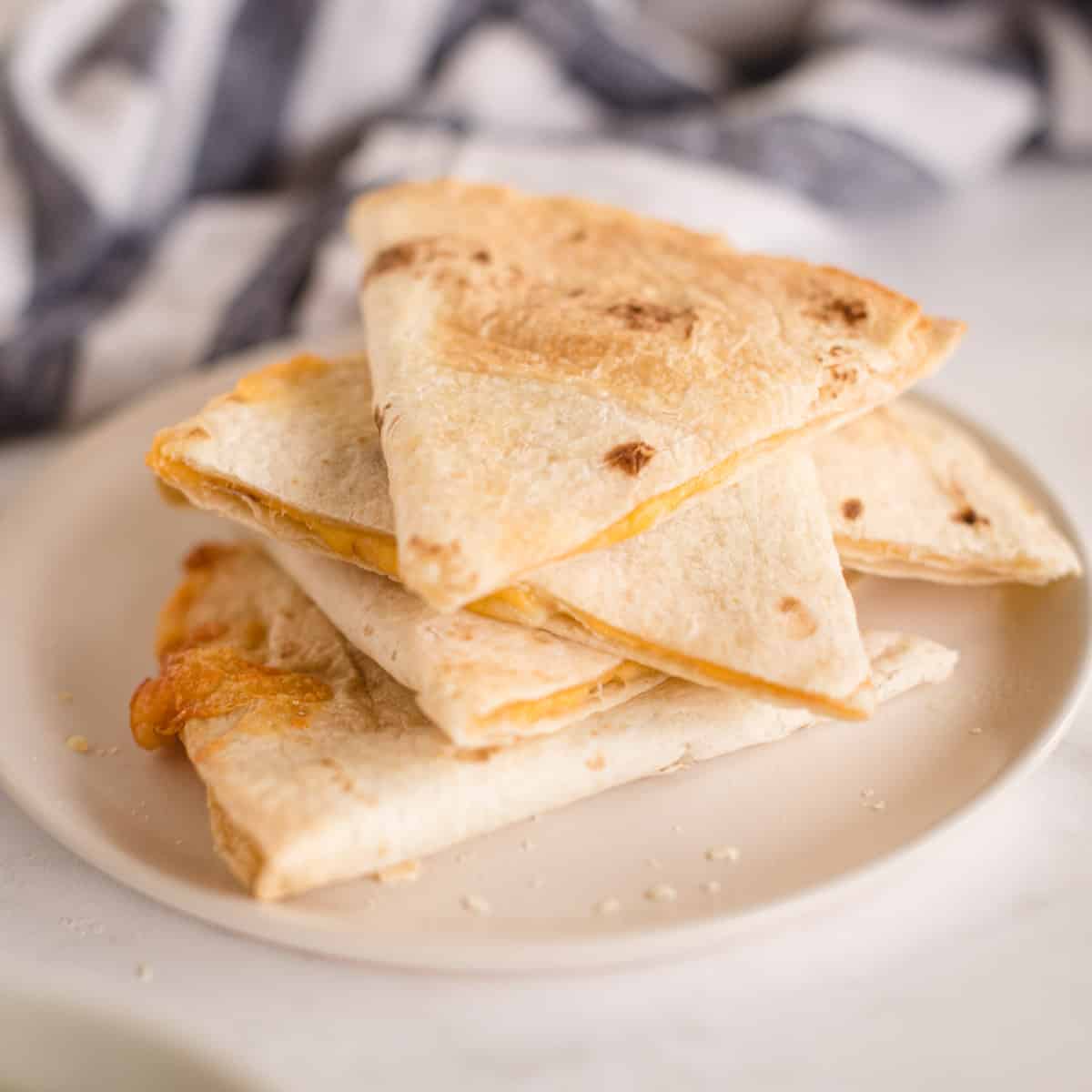 close up of stack of crispy cheese quesadillas
