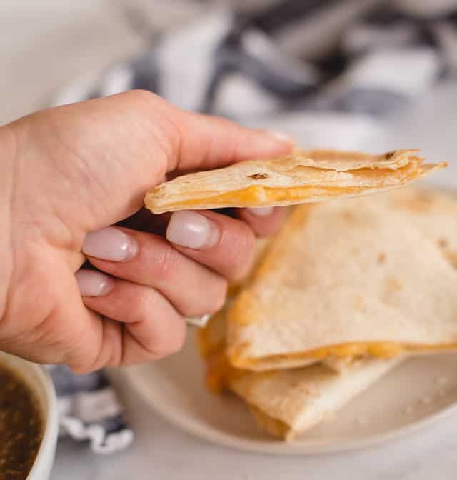 hand holding an air fryer cheese quesadilla
