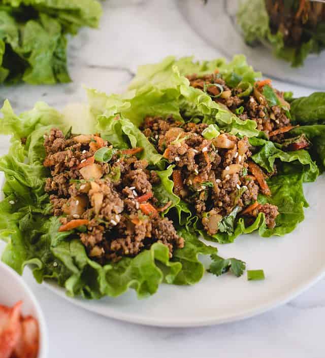 Side view of ground beef lettuce wraps on a plate