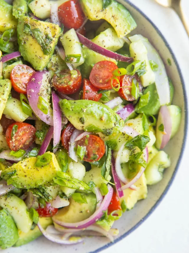 avocado, tomato and red onion tossed in a bowl