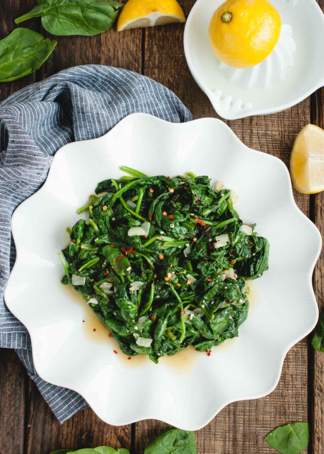 flat lay of sauteed spinach with crushed red pepper flakes and garlic