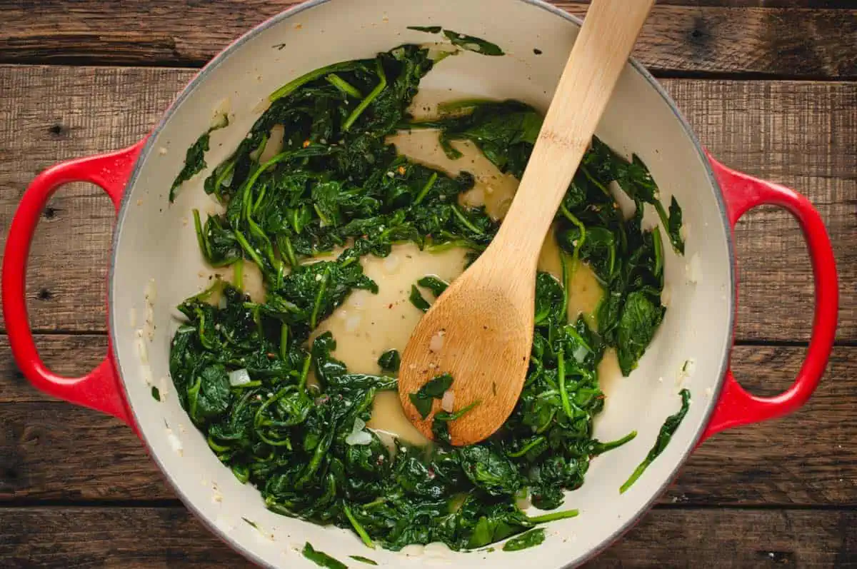 Large pot with cooked spinach in it
