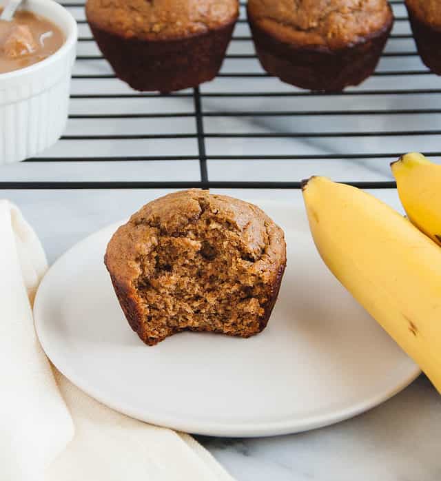 muffin sitting on a plate next to bananas