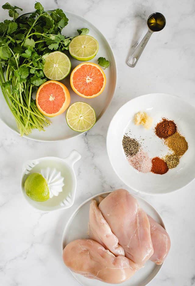 recipe ingredients with citrus, chicken, cilantro and spices