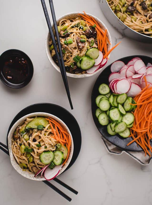 overhead vertical of bowls of miso noodles with vegetables
