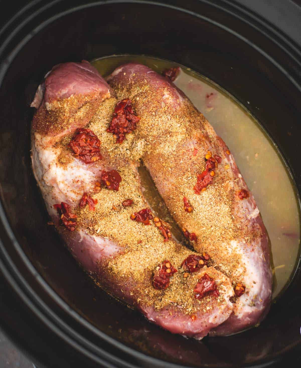 pork loins in a slow cooker with seasonings