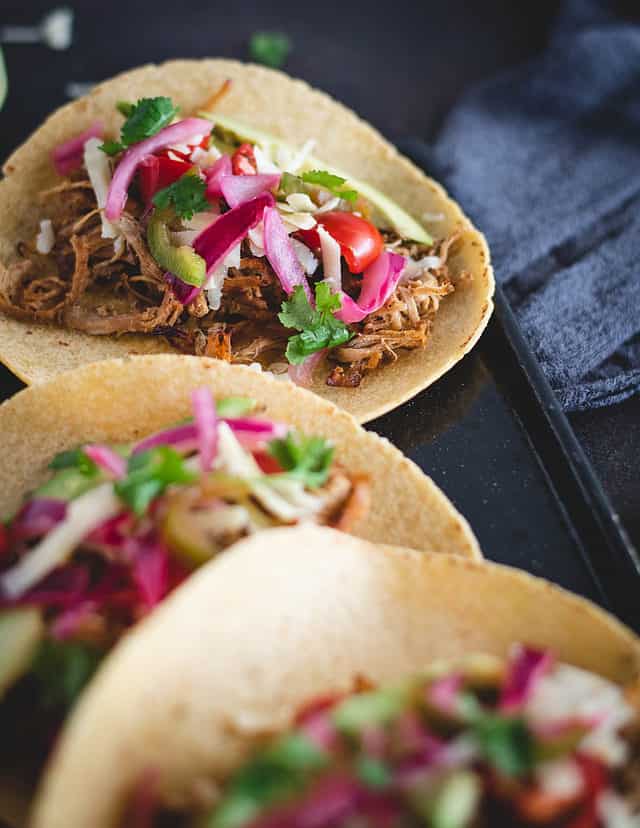 pork loin carnitas taco on a plate with other tacos