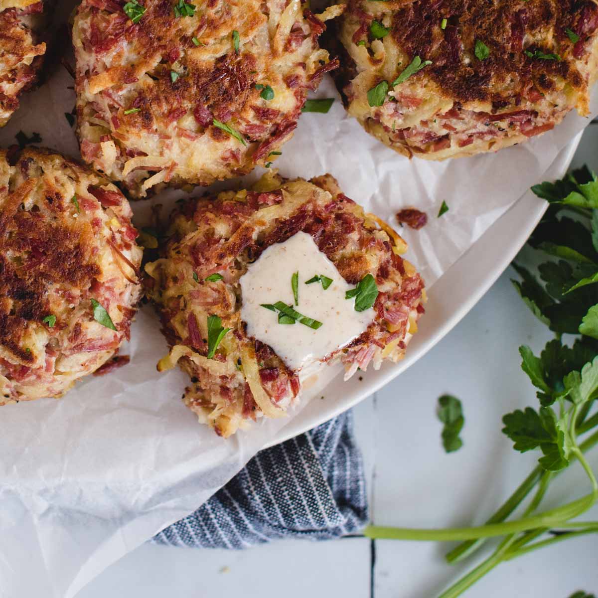 square overhead of corned beef fritters with mustard sauce on top