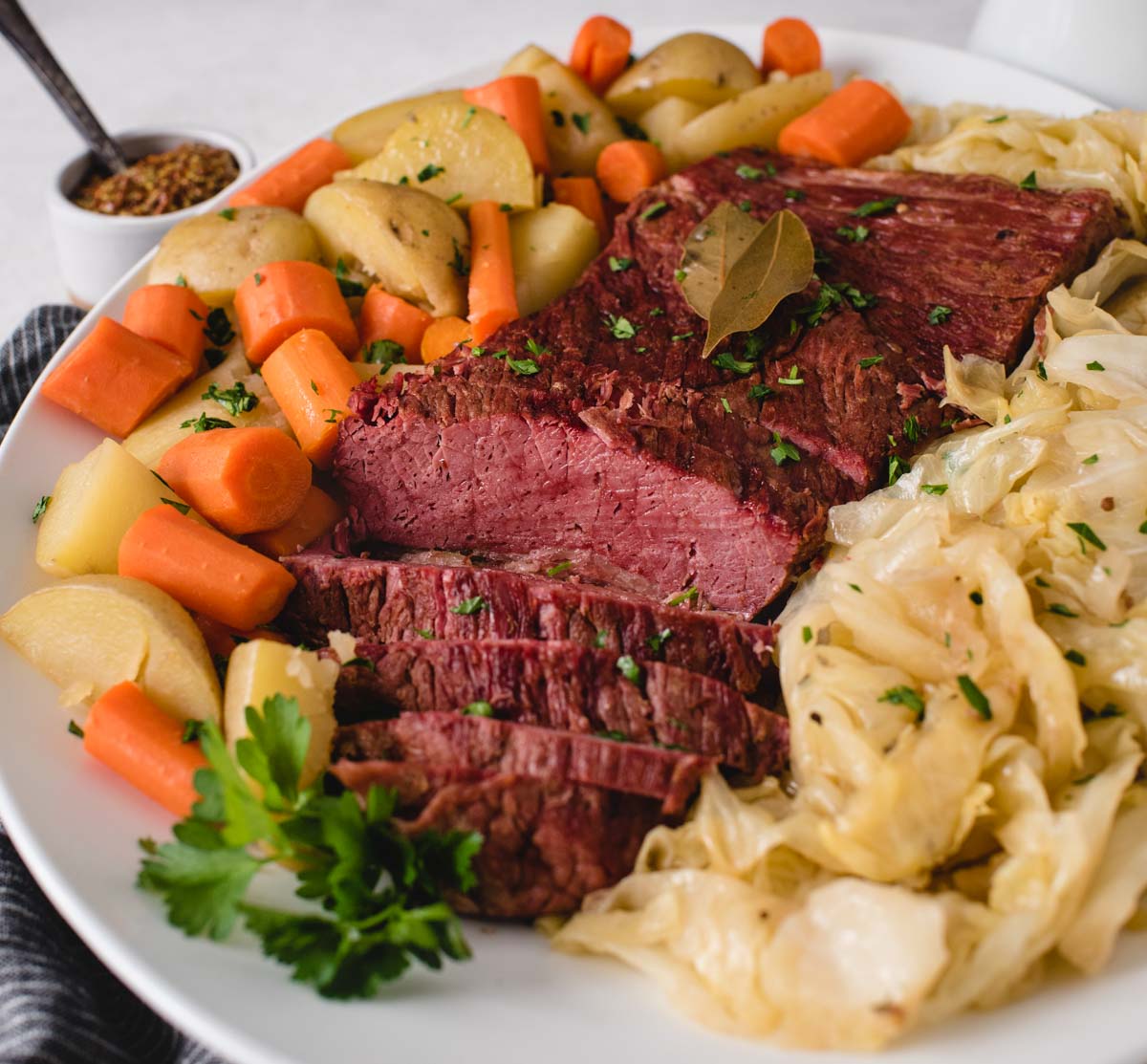 side view of corned beef on a serving platter with vegetables