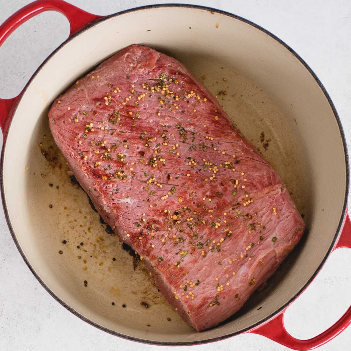 seared corned beef in a dutch oven