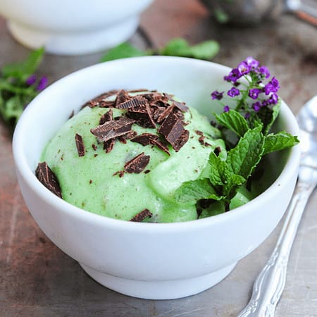 green mint ice cream in a bowl with chocolate on top