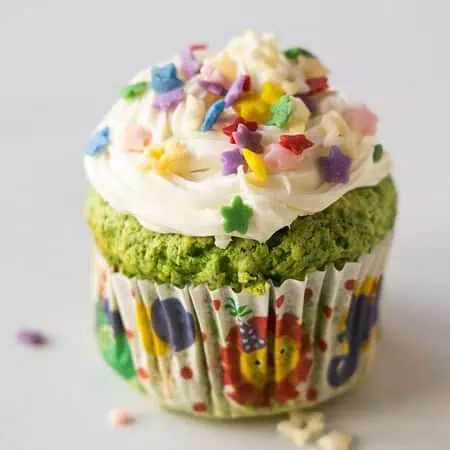 green cupcake with frosting and sprinkles