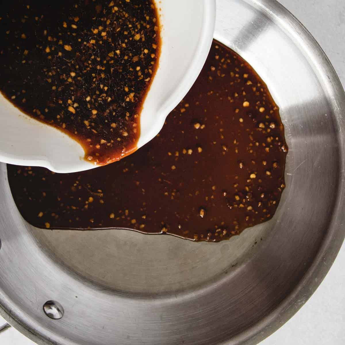 Teriyaki sauce being poured into a pan