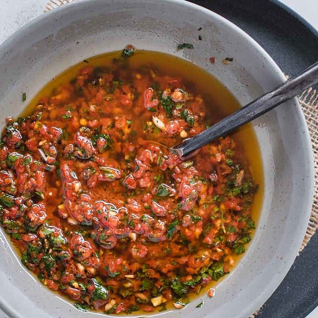 close up bowl of red chimichurri sauce from overhead