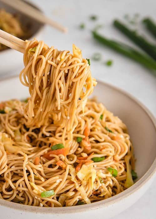 close up of teriyaki noodles being lifted up by chopsticks