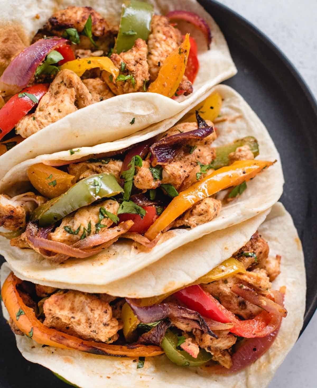 close up of air fryer chicken fajitas from overhead