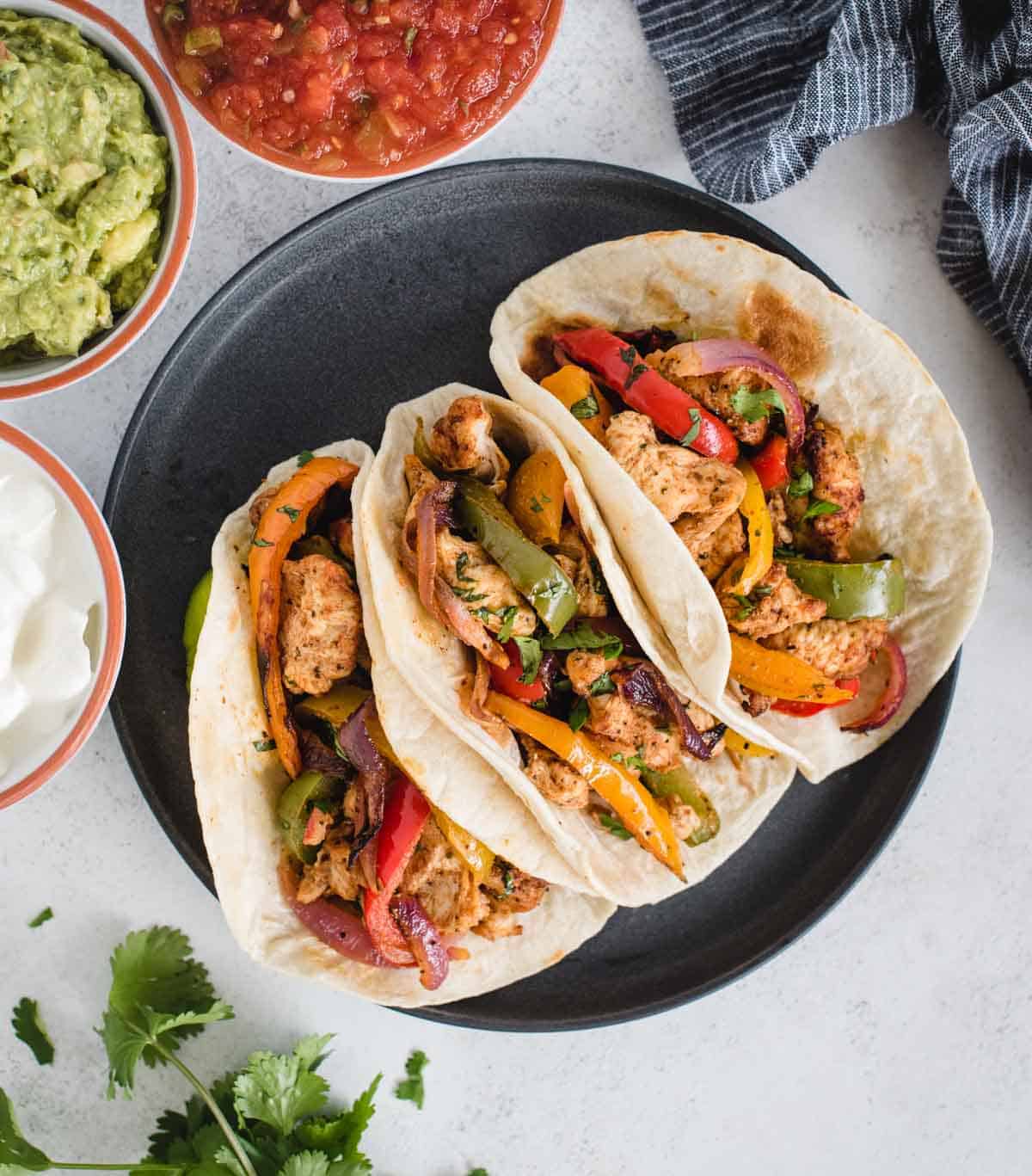 plate with three chicken fajitas from overhead