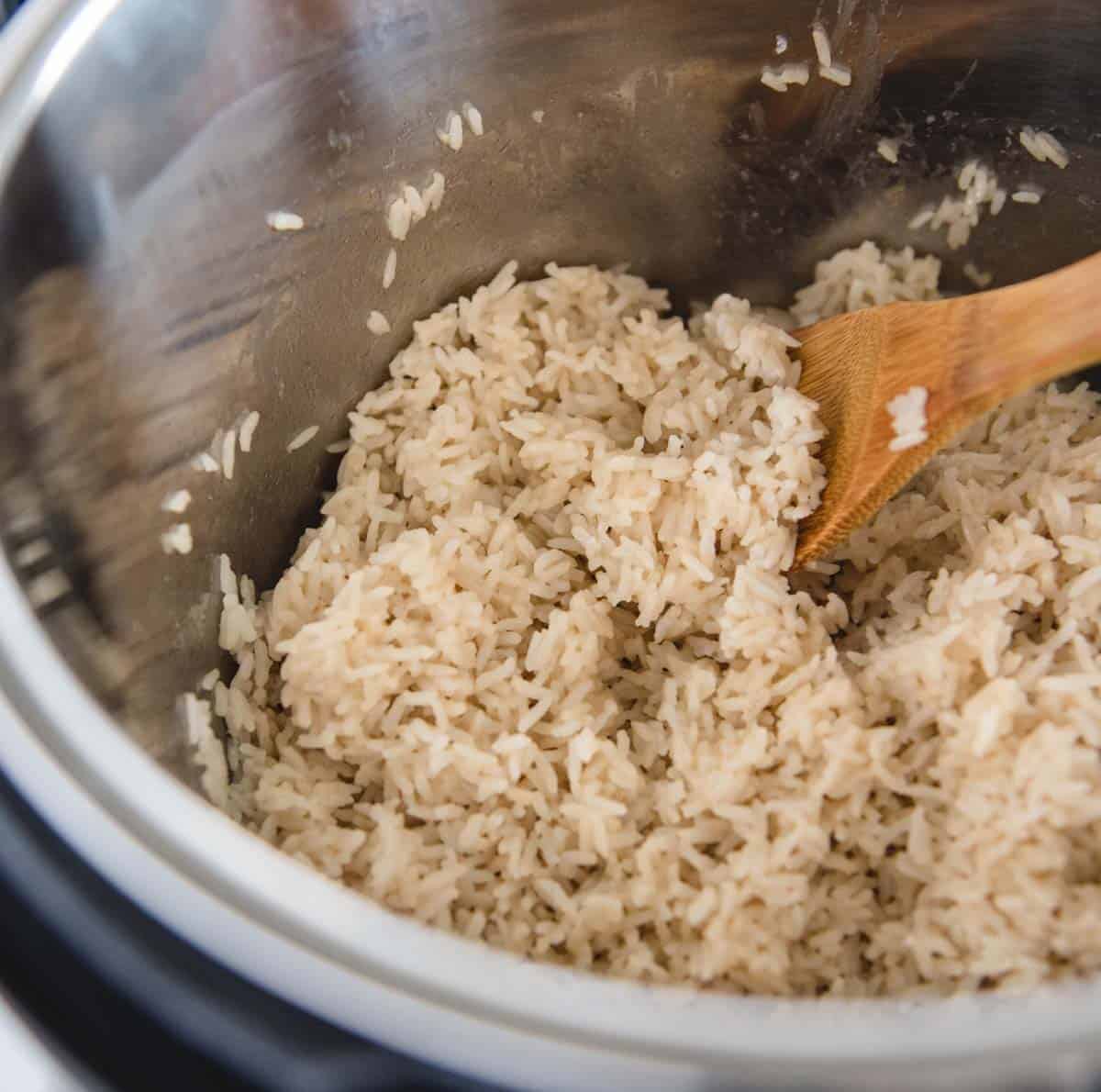 pot of rice from above with wooden spoon in it