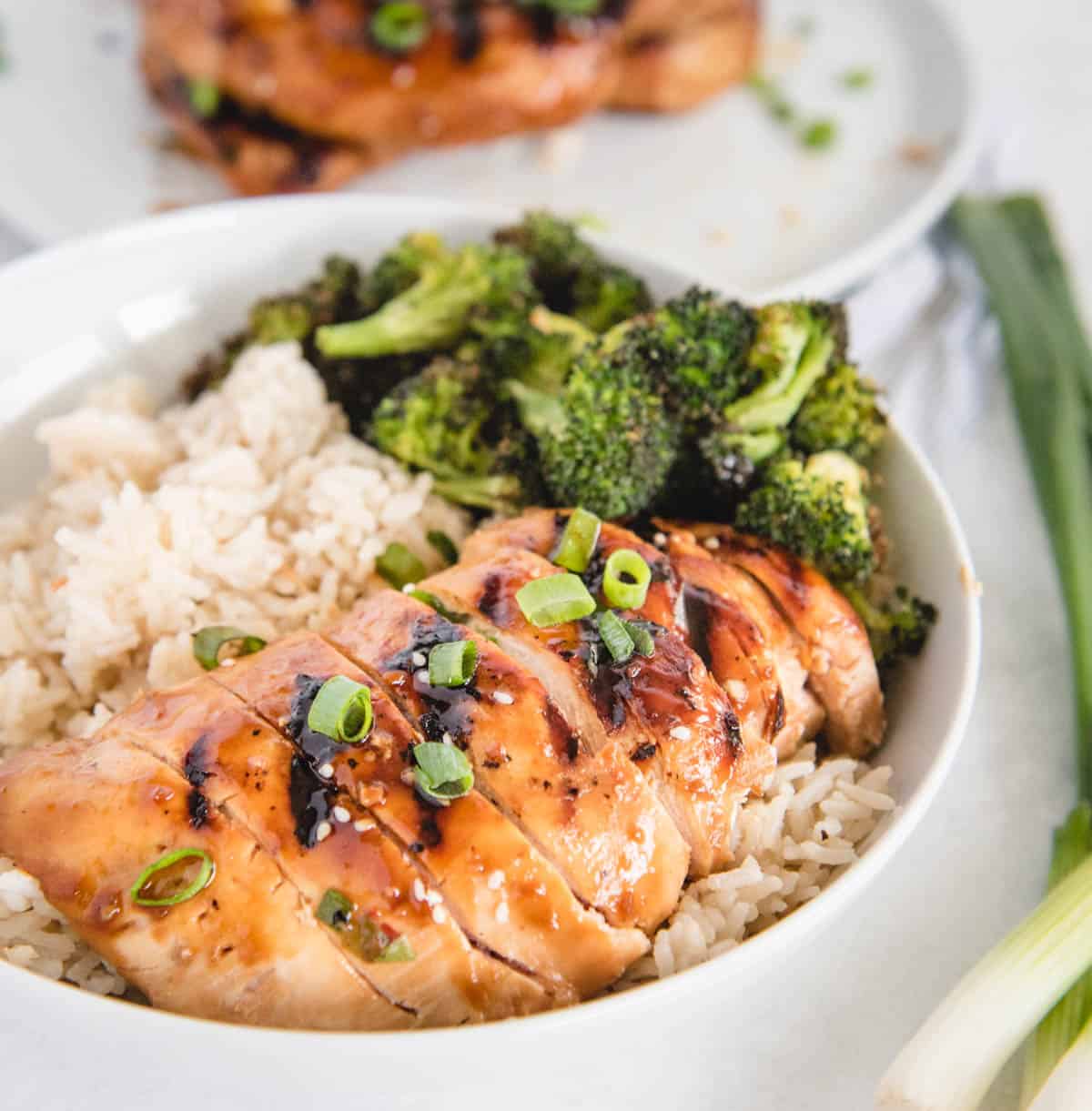 teriyaki chicken in a bowl with rice and broccoli from side view
