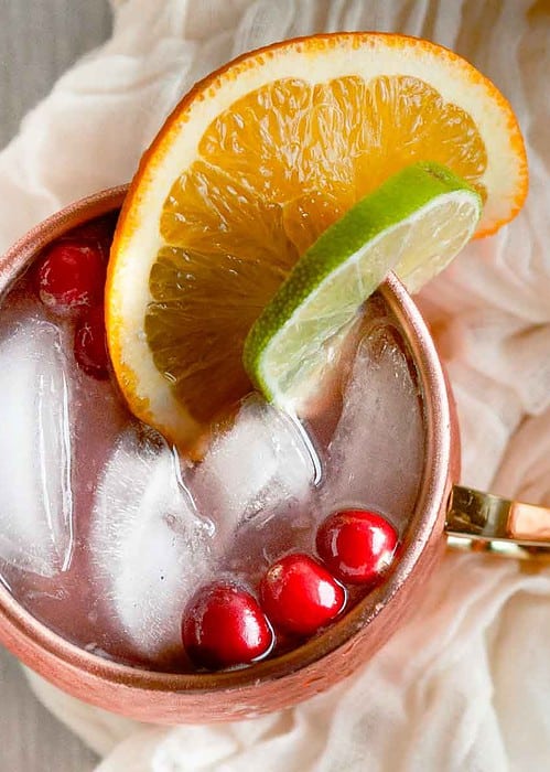 close up picture of cranberry moscow mule in a copper mug from overhead