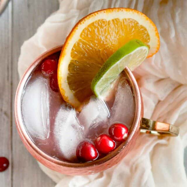close up picture of cranberry moscow mule in a copper mug from overhead
