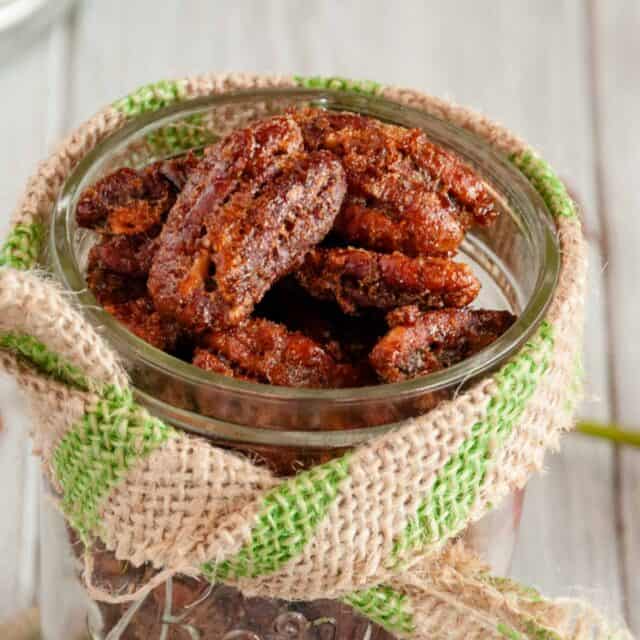 close up of spiced pecans in a jar