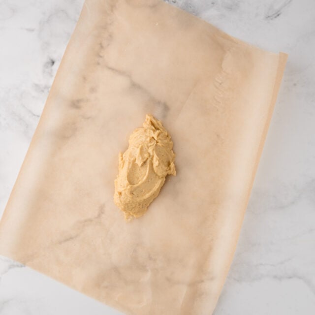 blob of butter compound on the center of a piece of parchment paper