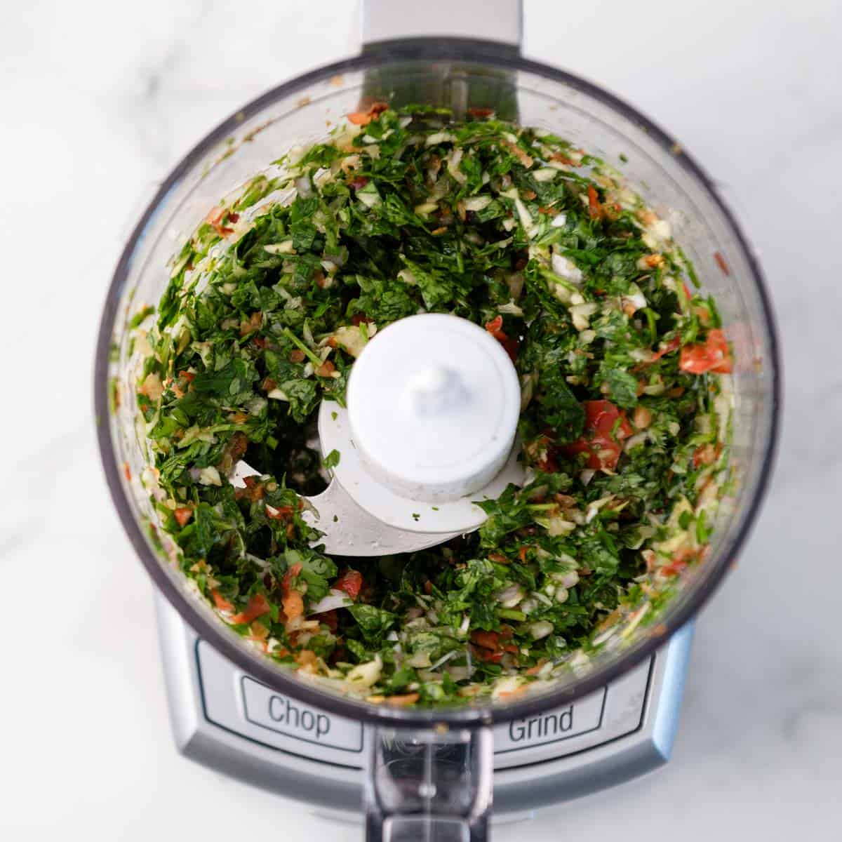 Blended up herbs, peppers and spices in a food processor