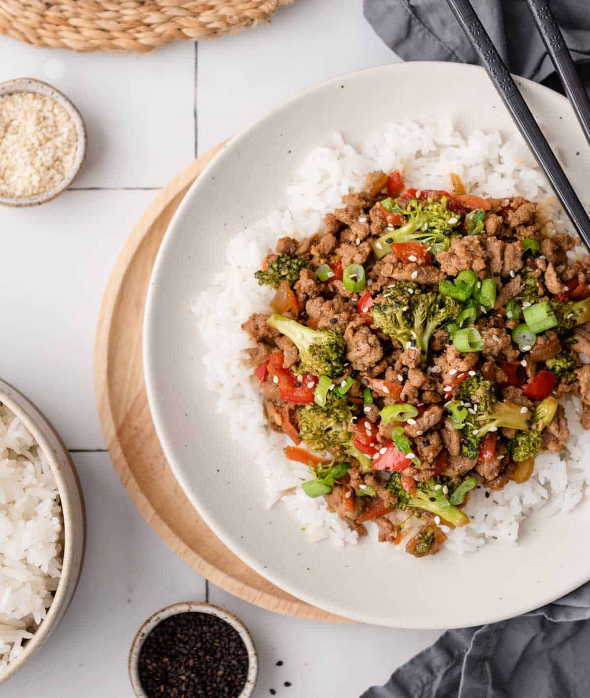 ground turkey and broccoli stir fry over white rice on styled background