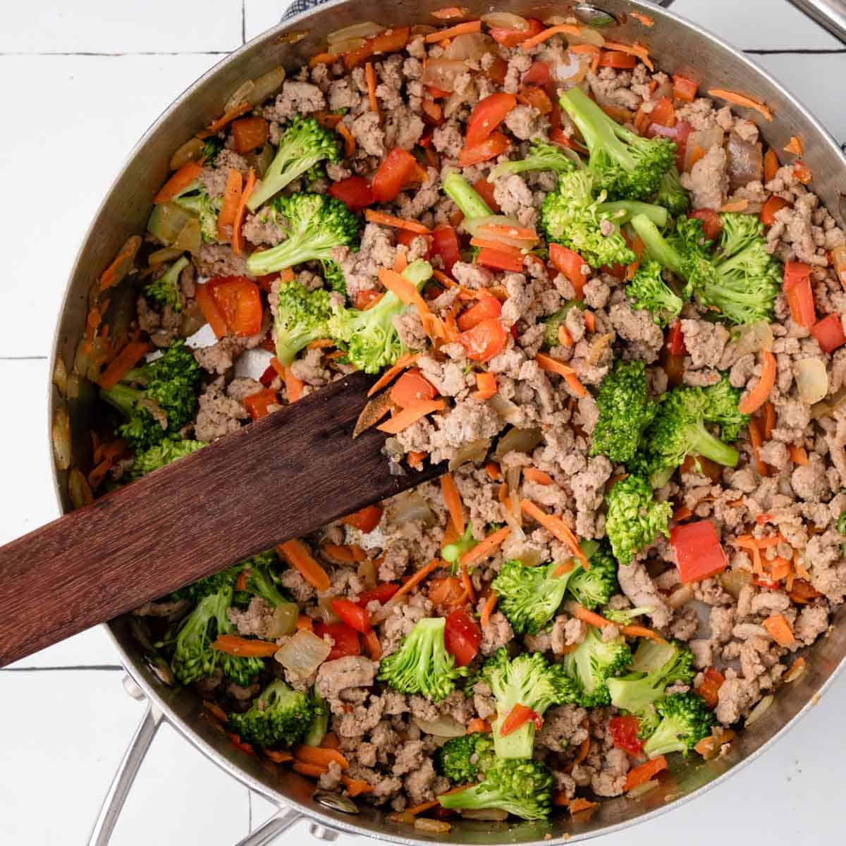 ground turkey, broccoli and other veggies cooked in a skillet