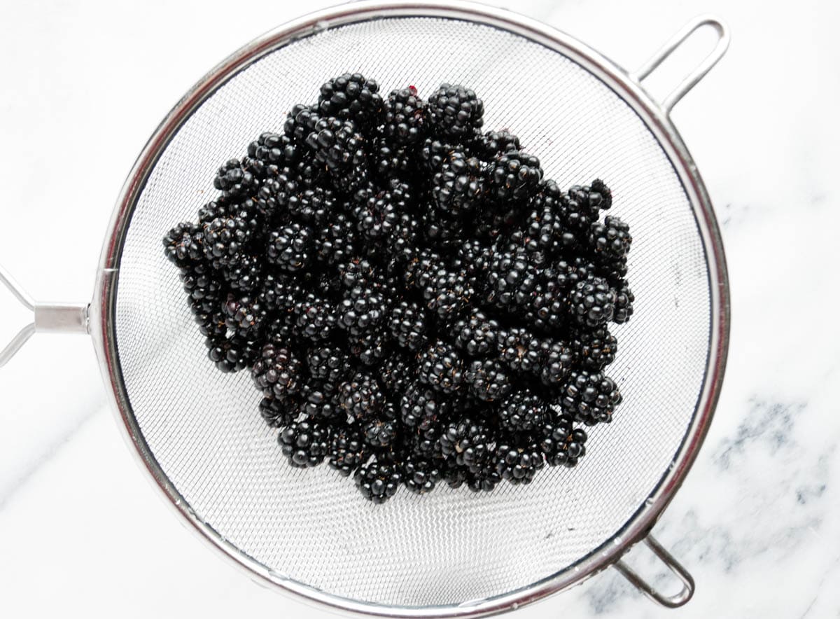 Fresh blackberries in a mesh strainer
