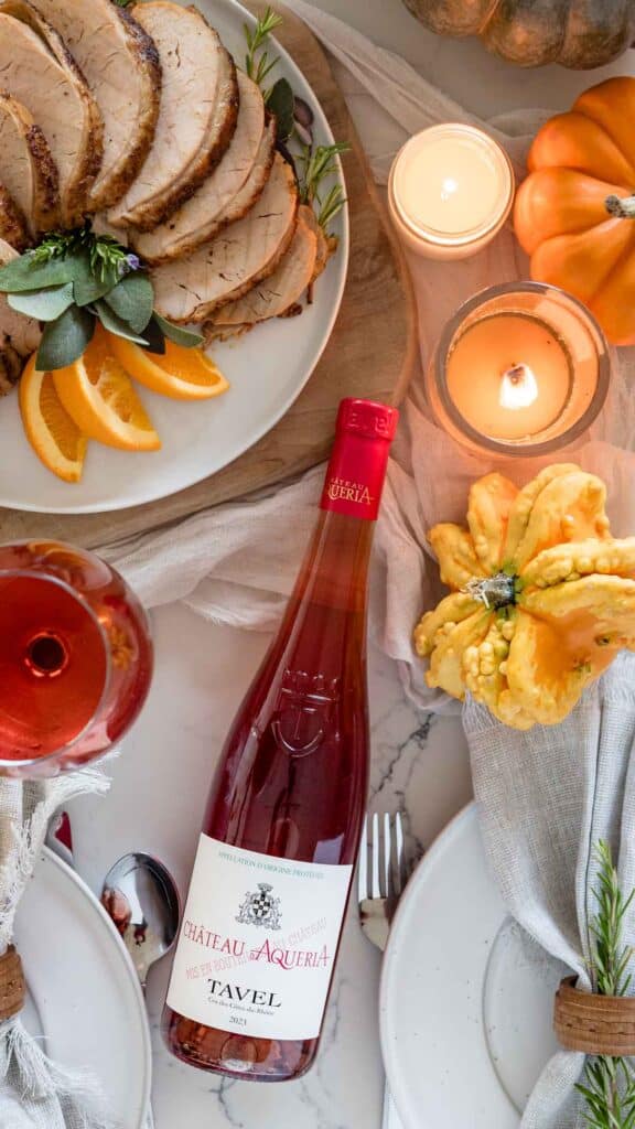 bottle of rose wine next to plated thanksgiving turkey breast