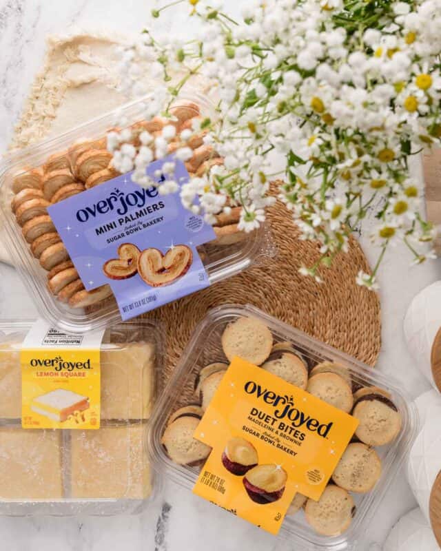 overjoyed brand baked products in plastic packaging with white flowers on the table