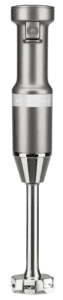 A silver KitchenAid immersion blender with a power button and blending attachment, standing upright—perfect for effortlessly preparing creamy Roasted Garlic Tomato Soup.